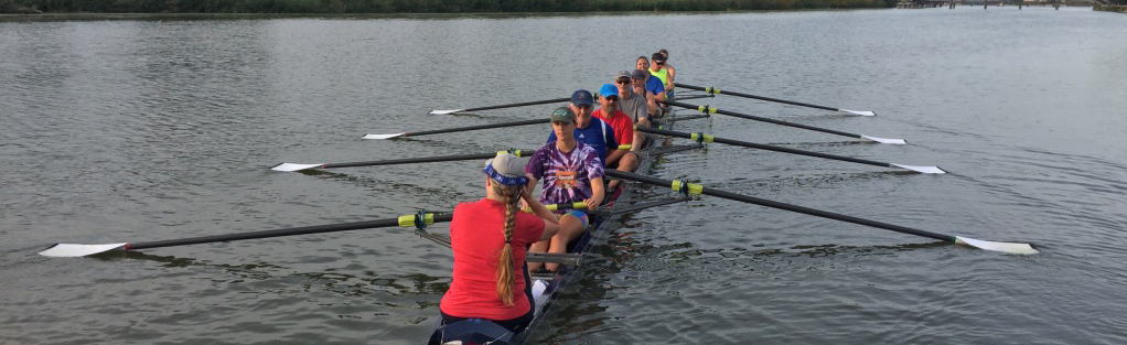 An eight shell launches from the dock